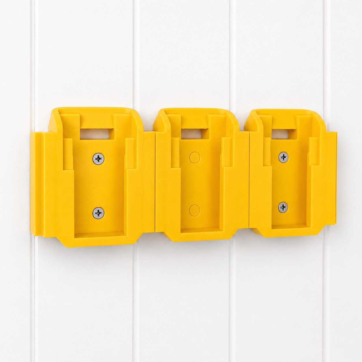 Yellow DeWalt plastic battery holders with multiple compartments on a white background