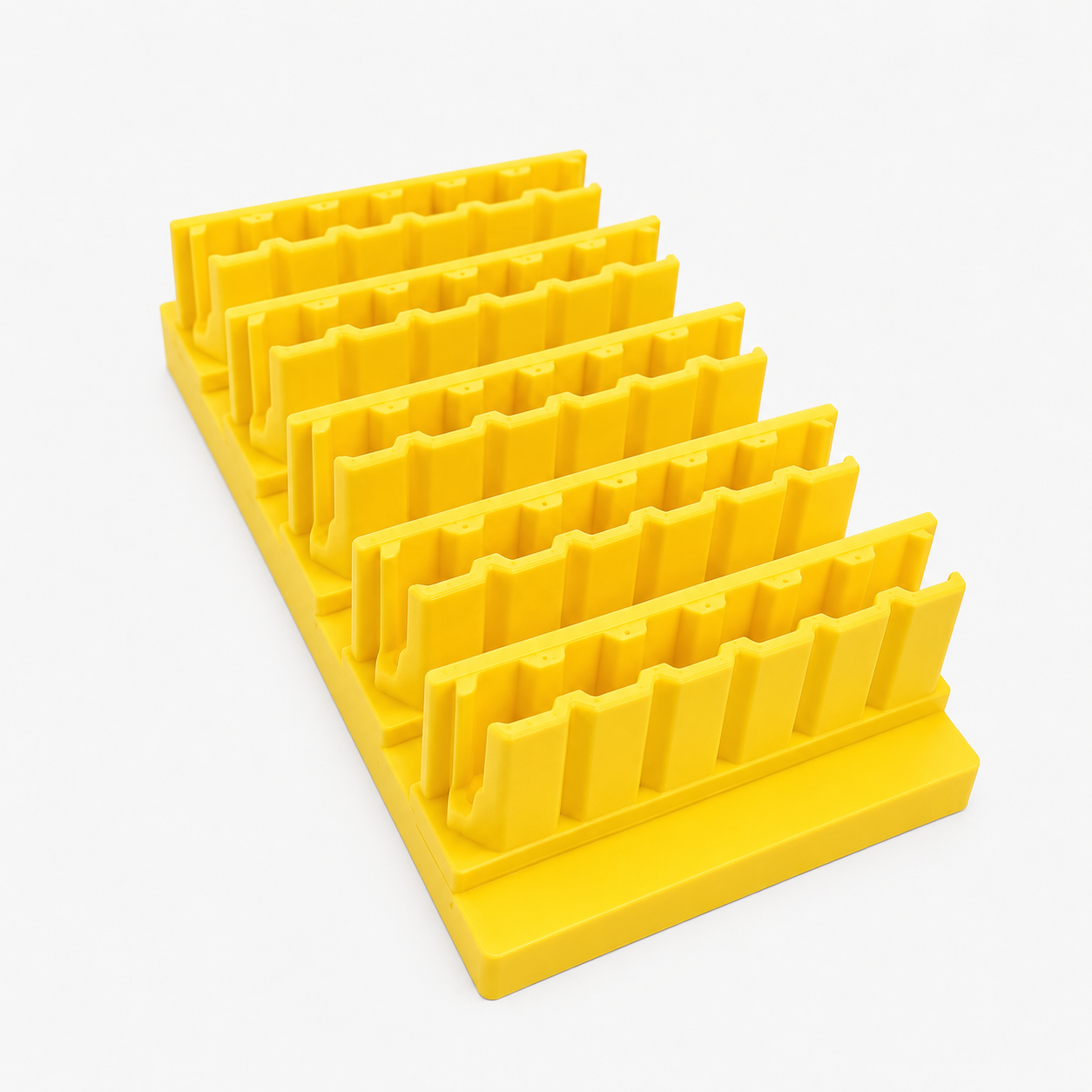 Yellow plastic drill and impact driver bit organizer with multiple compartments on a white background