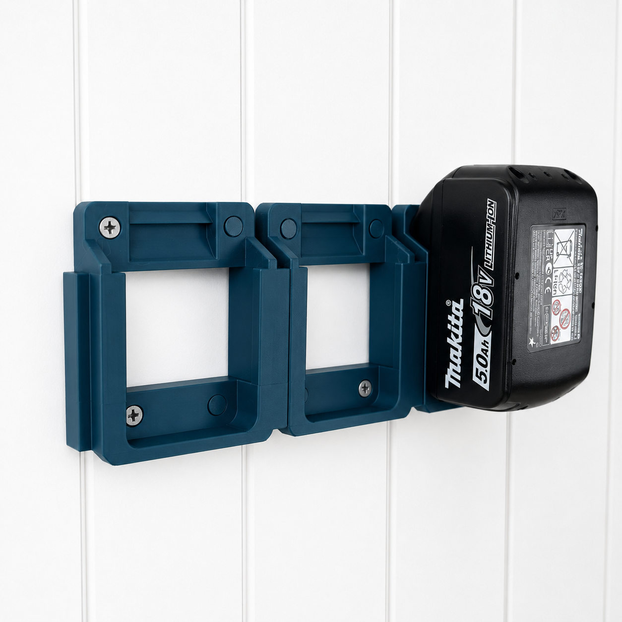 Blue Makita battery holder with a battery attached on a white wooden background