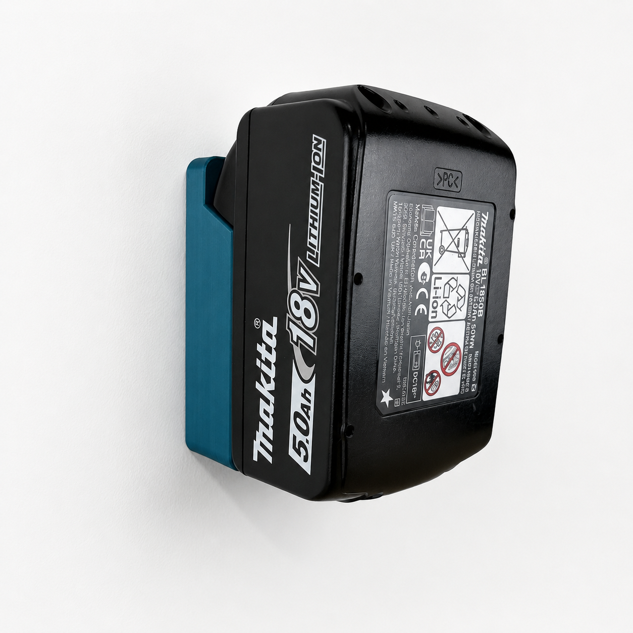 Makita battery in a Makita wall bracket on a white background