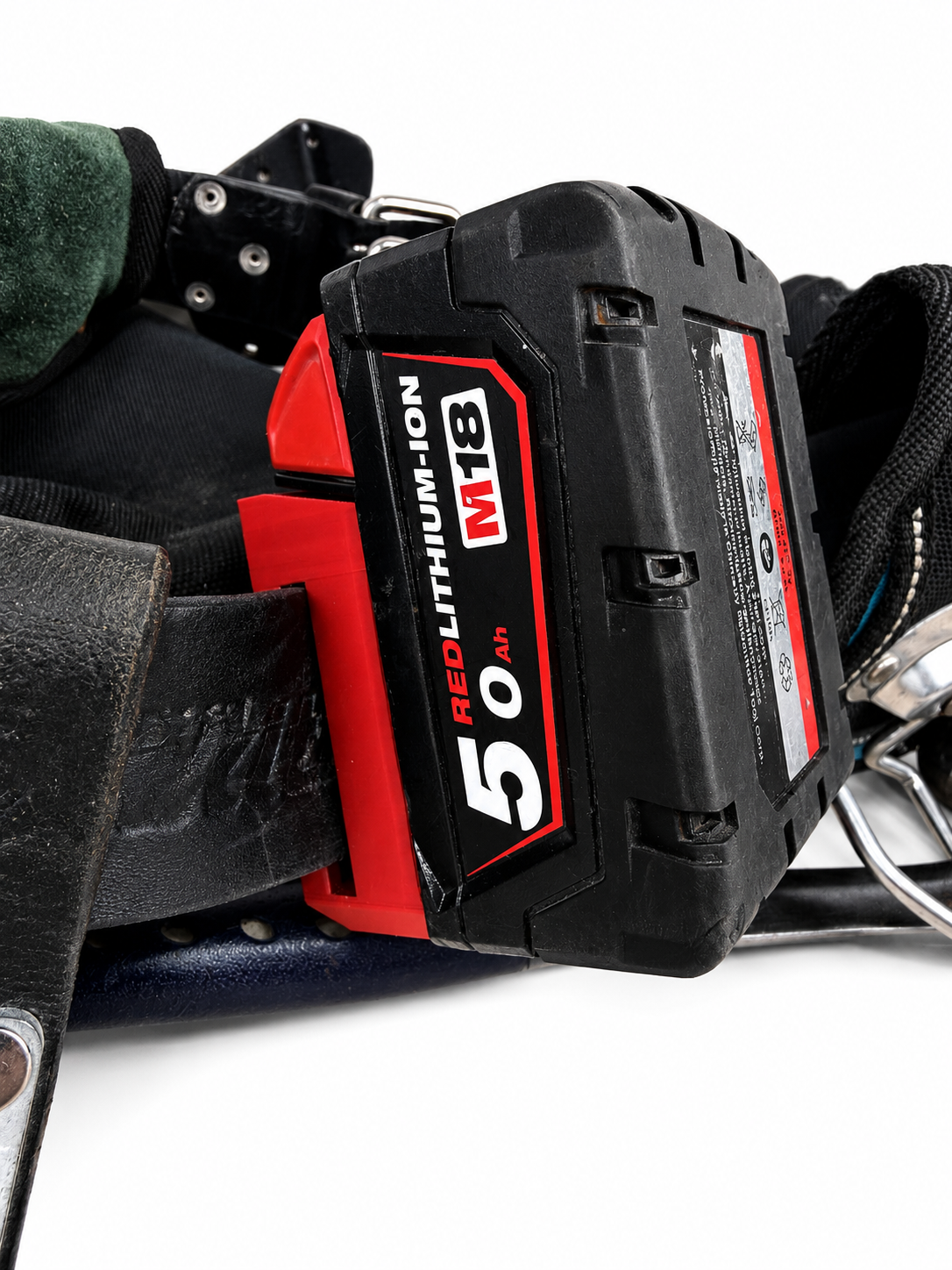 Red Milwaukee M18 battery pack on a tool belt on a white background