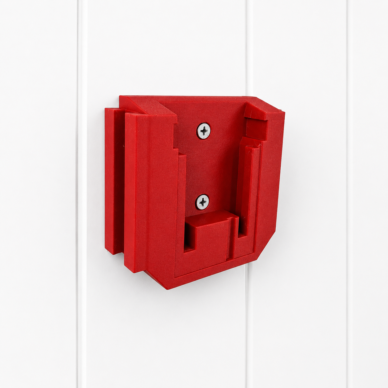 Red Milwaukee plastic wall mount bracket on a white background