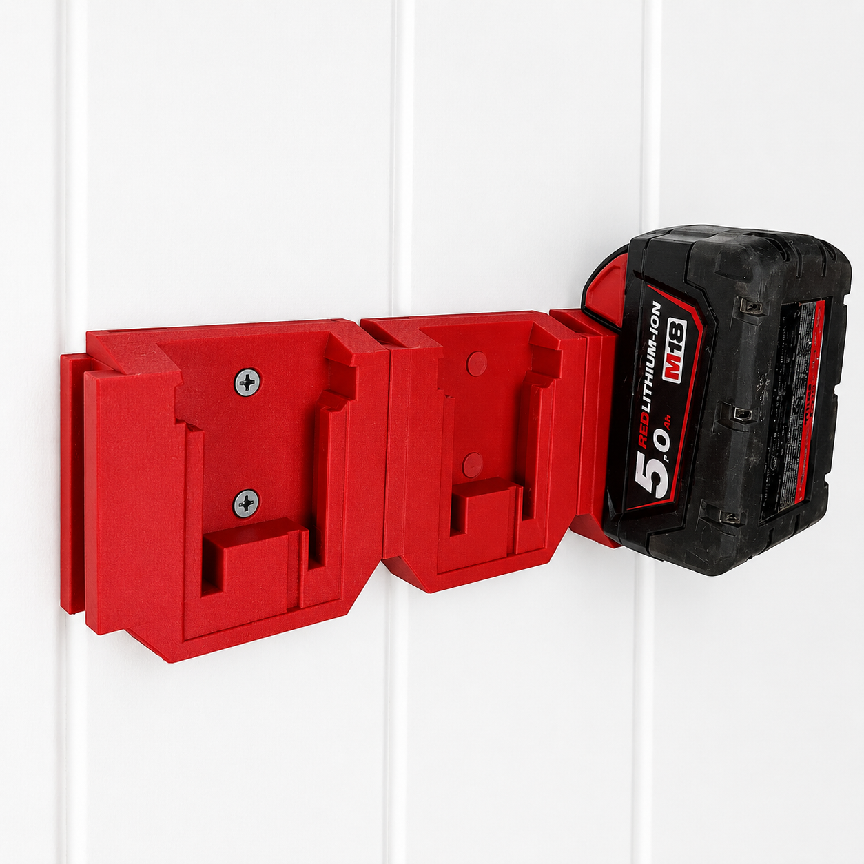 Red Milwaukee tool holder with a black and red M18 battery attached on a white background