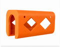 Orange tool holder with diamond-shaped cutouts on a white background