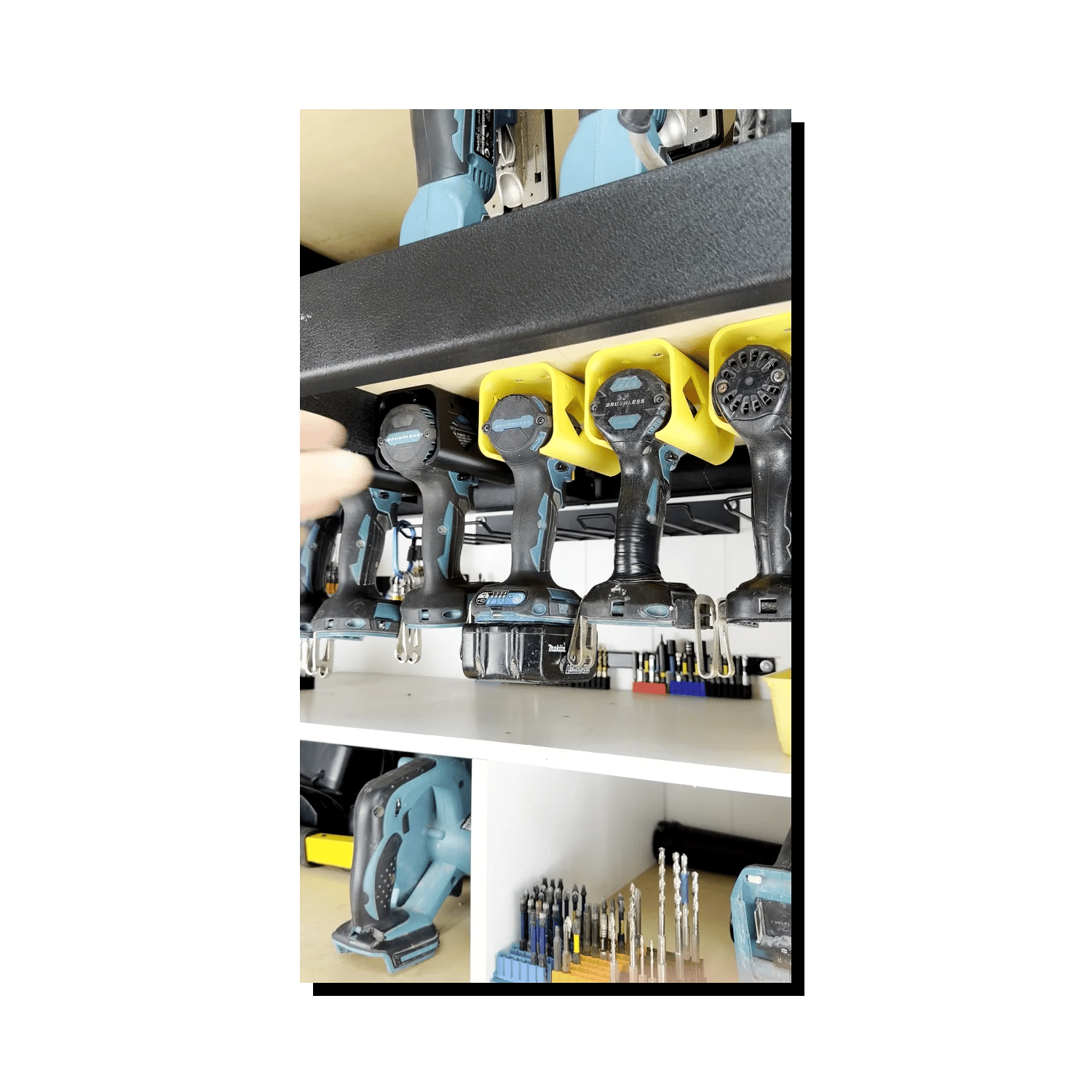 Collection of Makita power tools on a shelf stored in tool holsters
