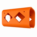 Orange plastic tool holder with geometric cutouts on a white background