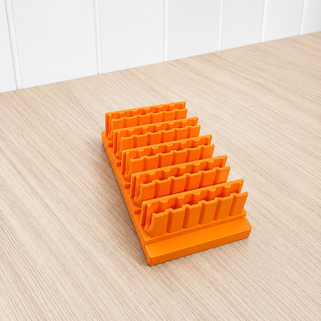 Set of orange bit holders on a wooden surface with white paneling in the background